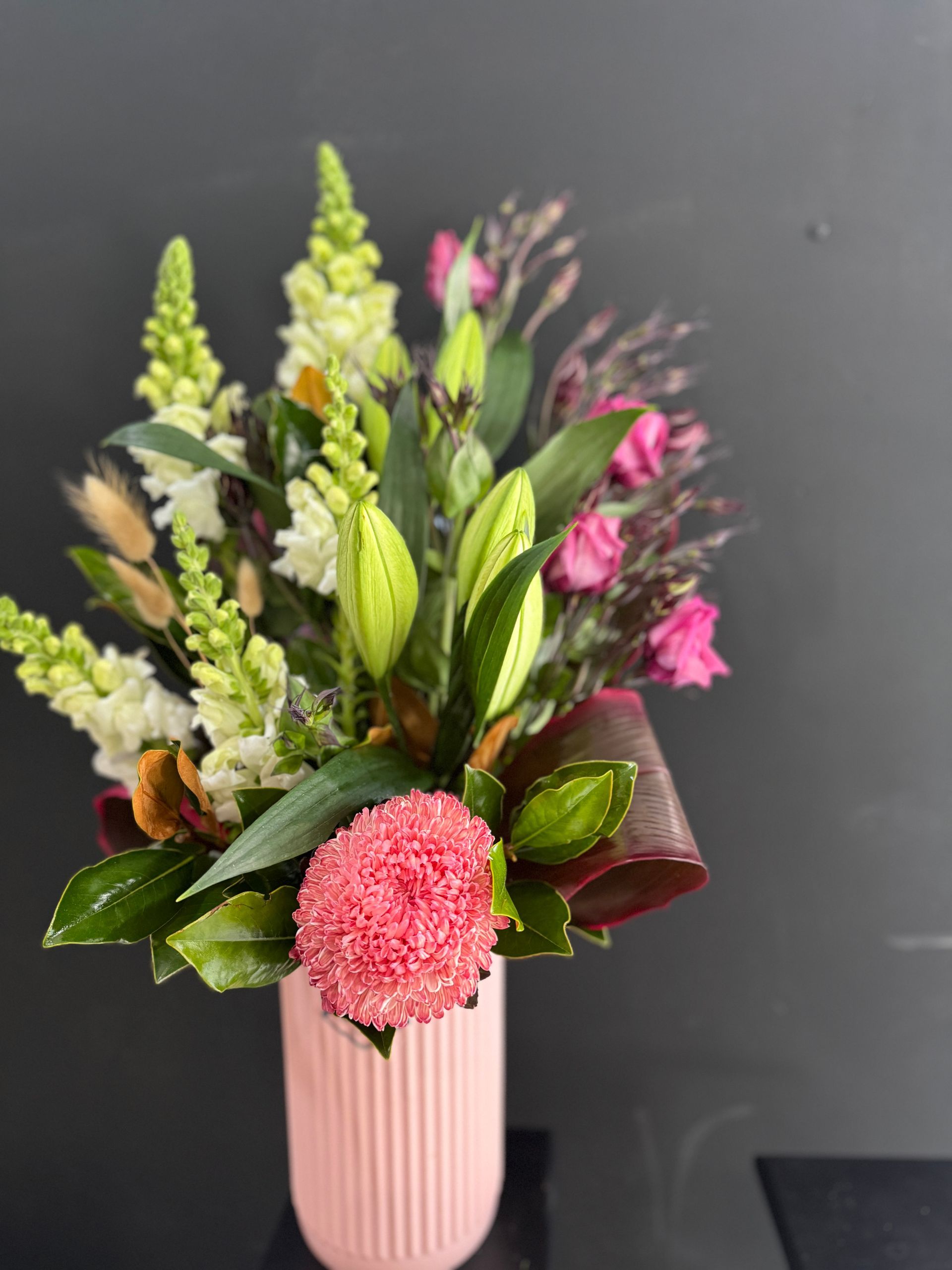 Pink Floral Arrangement in a Light Pink Vase Against a Black Background — J'adore Flowers & Gifts Cairns in Earlville, QLD