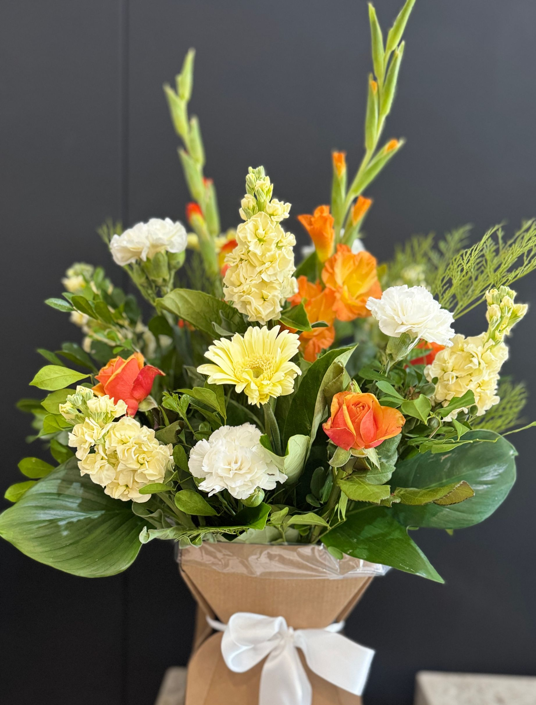 Floral Arrangement With Orange Roses and Gerbera Daisies — J'adore Flowers & Gifts Cairns in Earlville, QLD