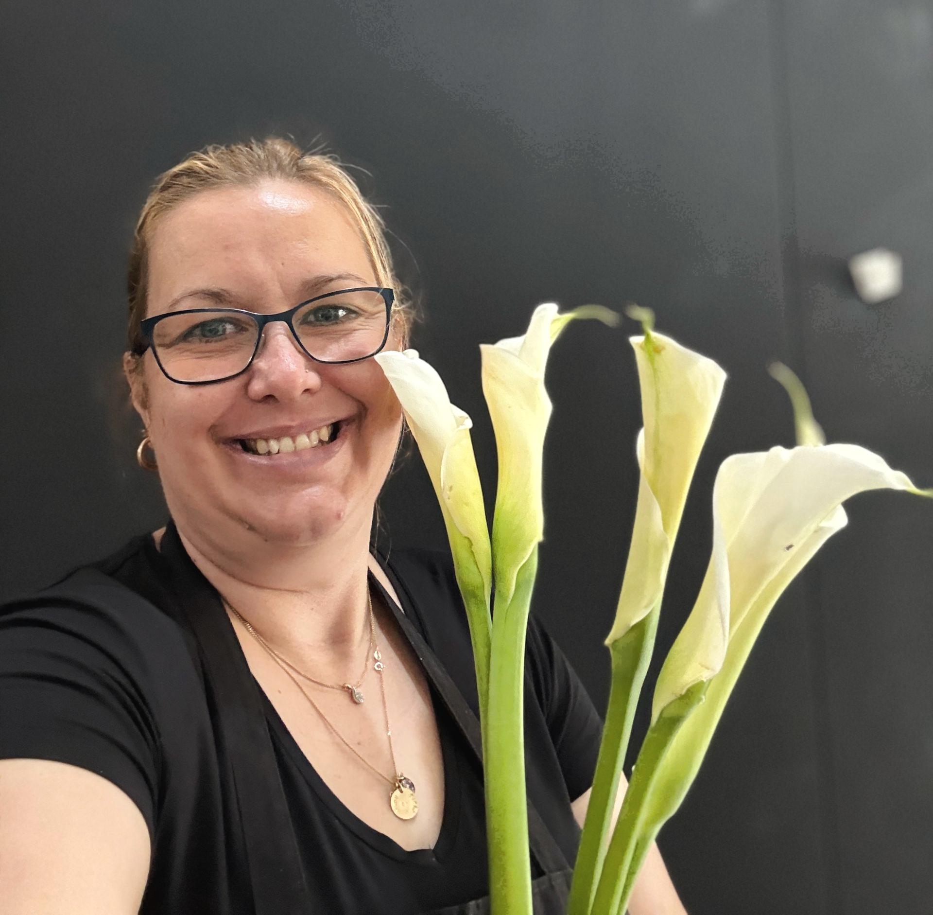 A Lady Holding cream colored flowers 