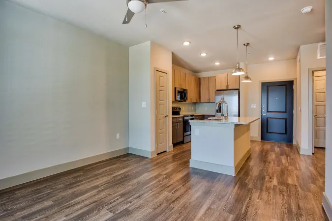 Modern kitchen with hardwood-style flooring at Three77 Park in Fort Worth, TX.