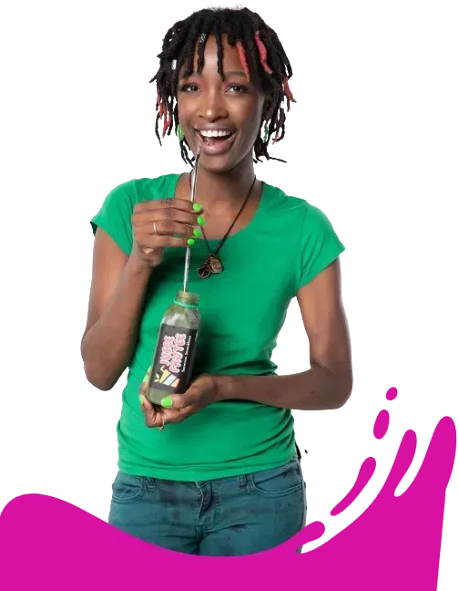 A woman in a green shirt is holding a bottle of juice