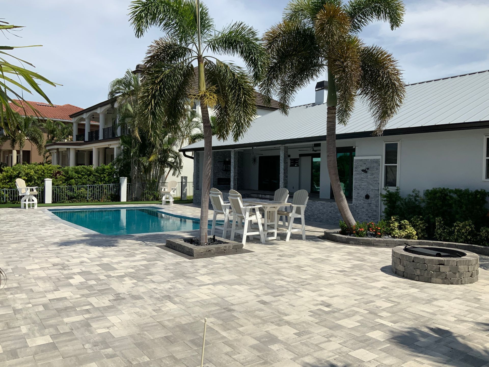 A large white house with a swimming pool in front of it