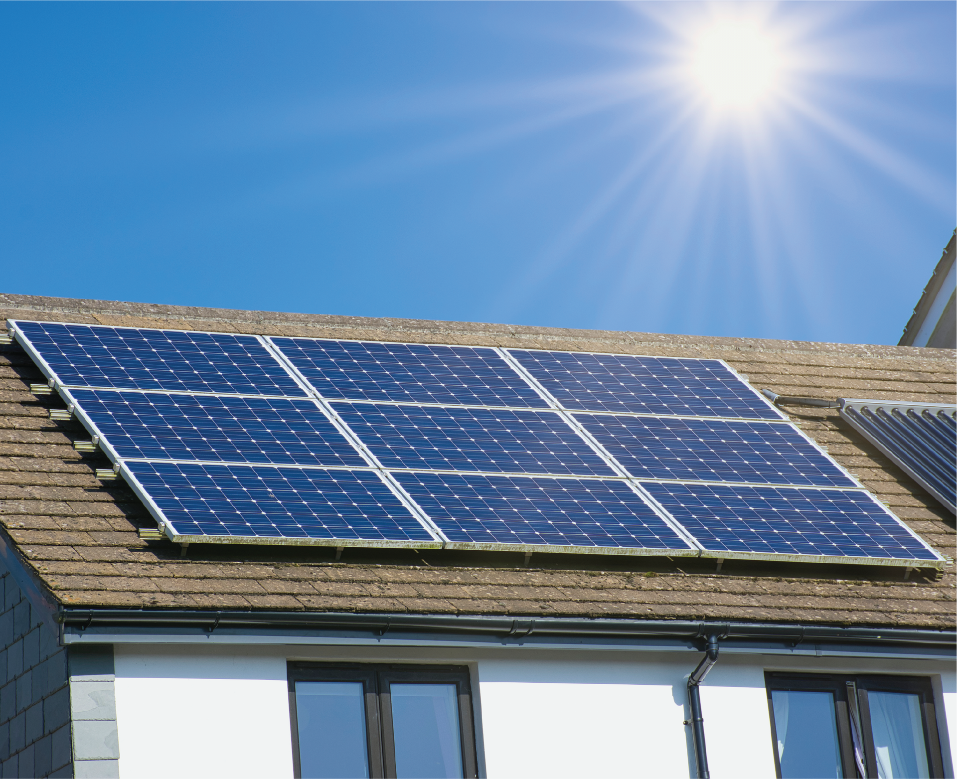 A row of solar panels on the roof of a house