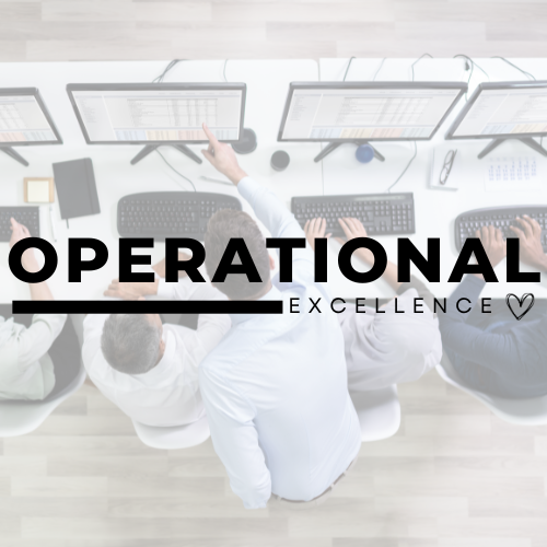 A group of people are sitting at a desk using computers.