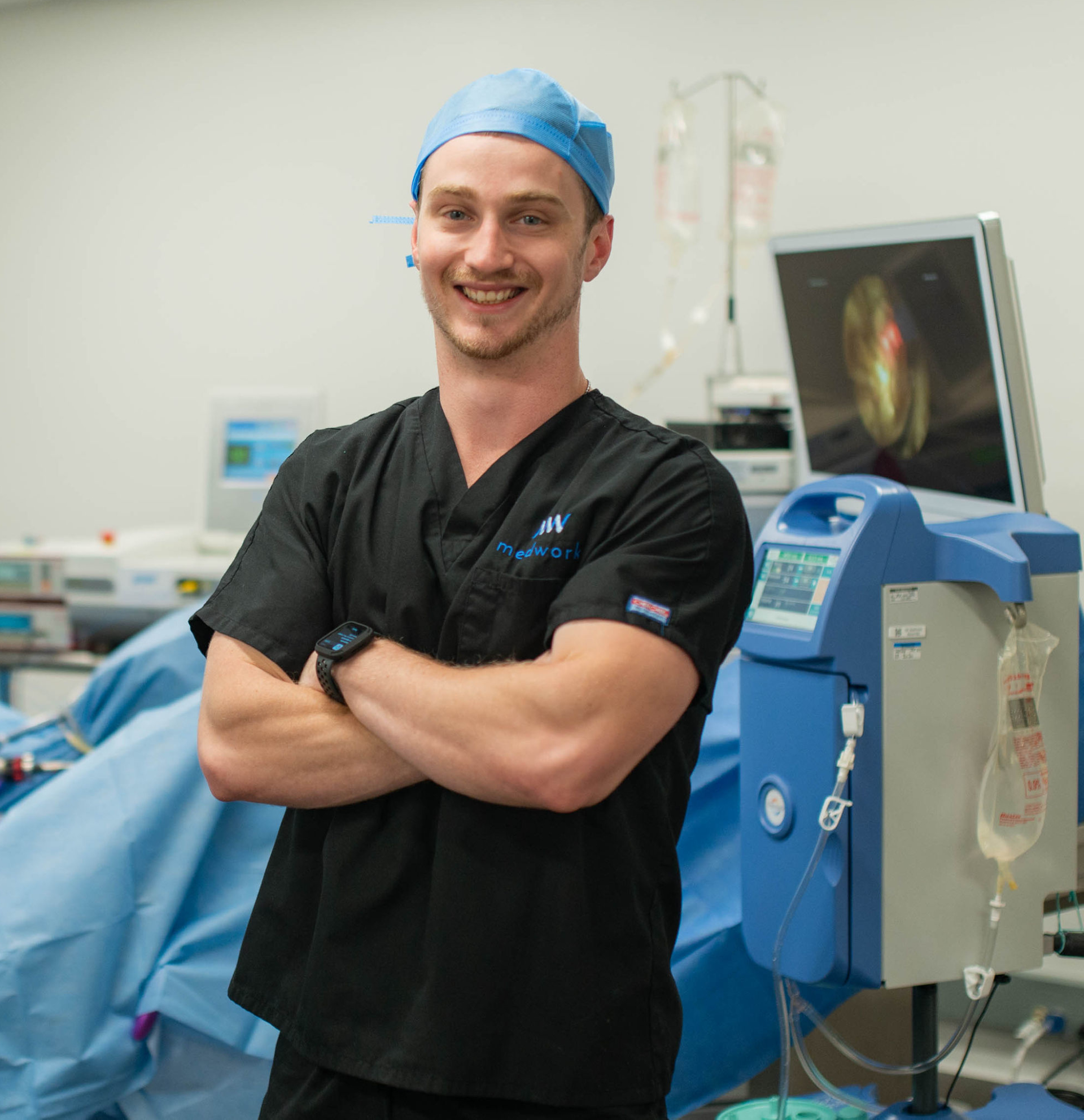 A man in an operating room with his arms crossed