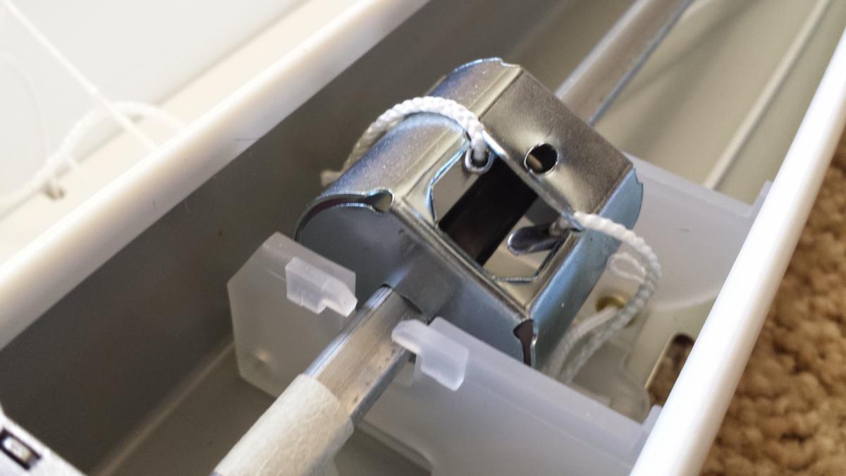 A small metal object is sitting in a plastic container.