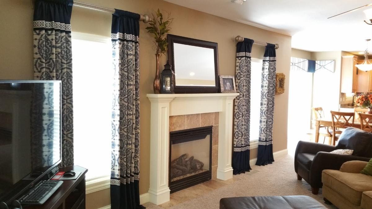 A living room with a fireplace and a television