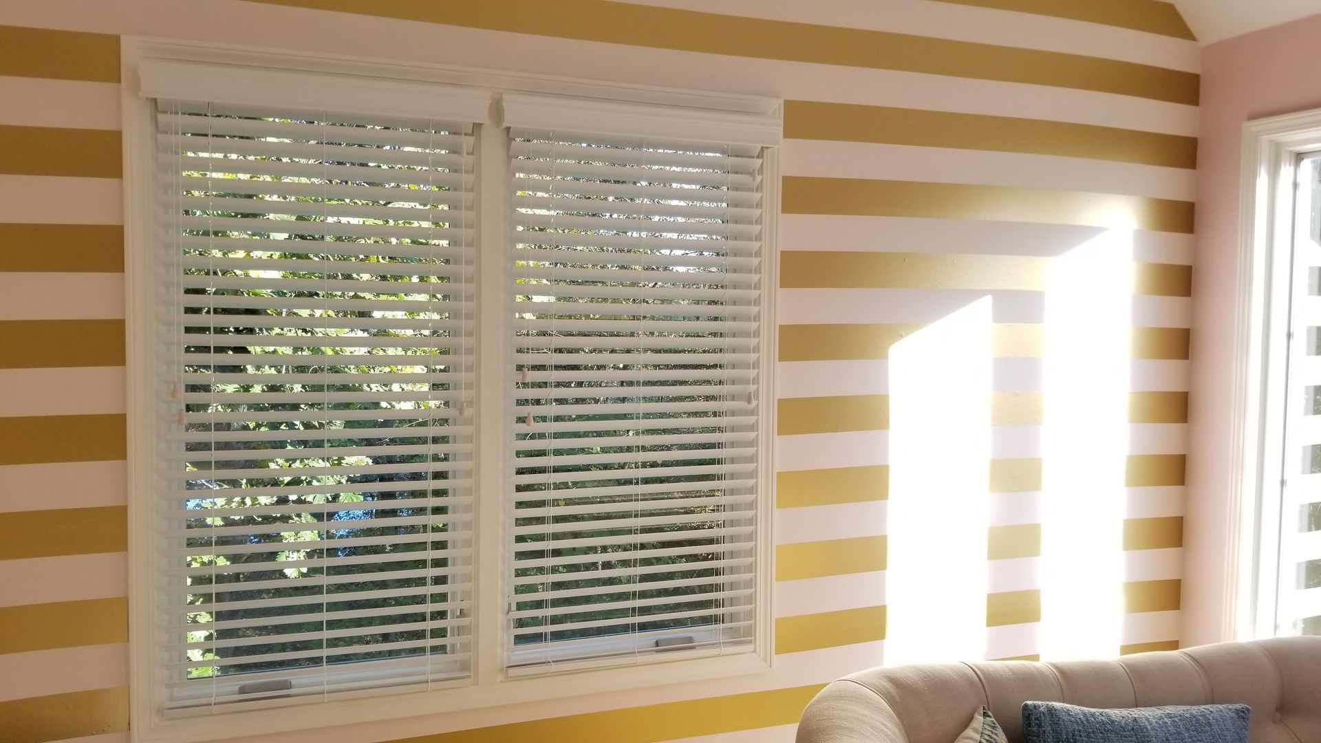 A living room with a striped wall and a couch