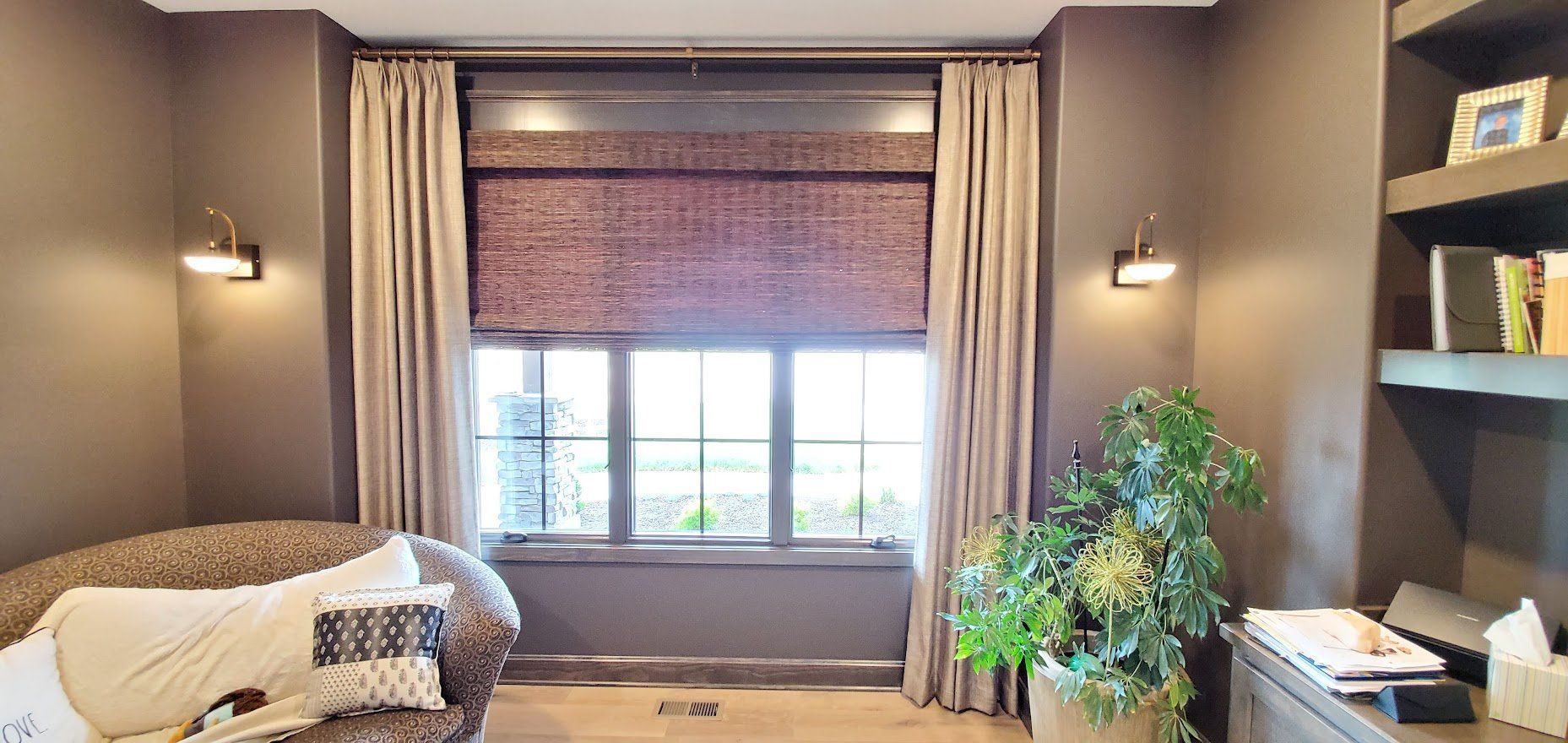 A living room with a large window and a couch.