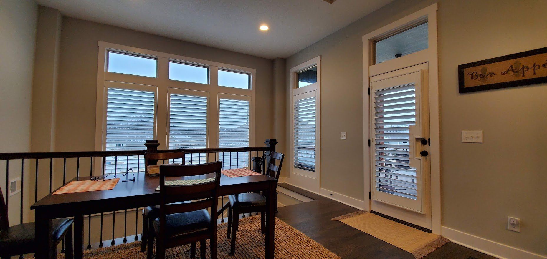 A dining room with a table and chairs and a door