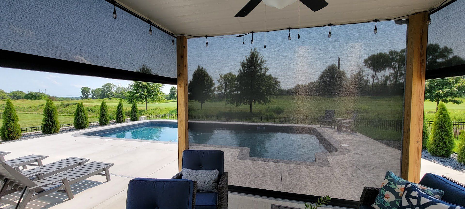 A patio with a swimming pool and a ceiling fan.
