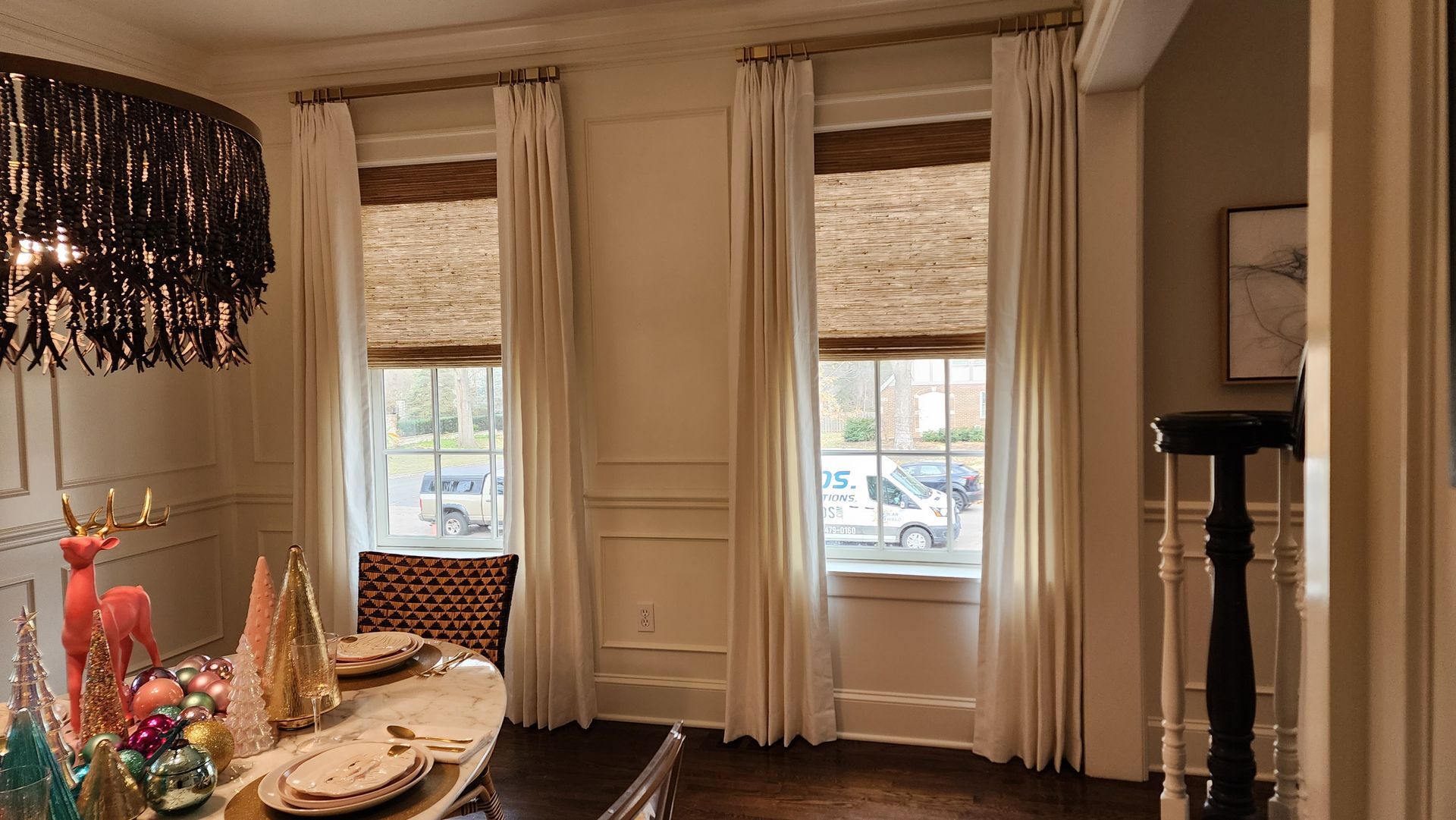 A dining room with a table and chairs and a chandelier.