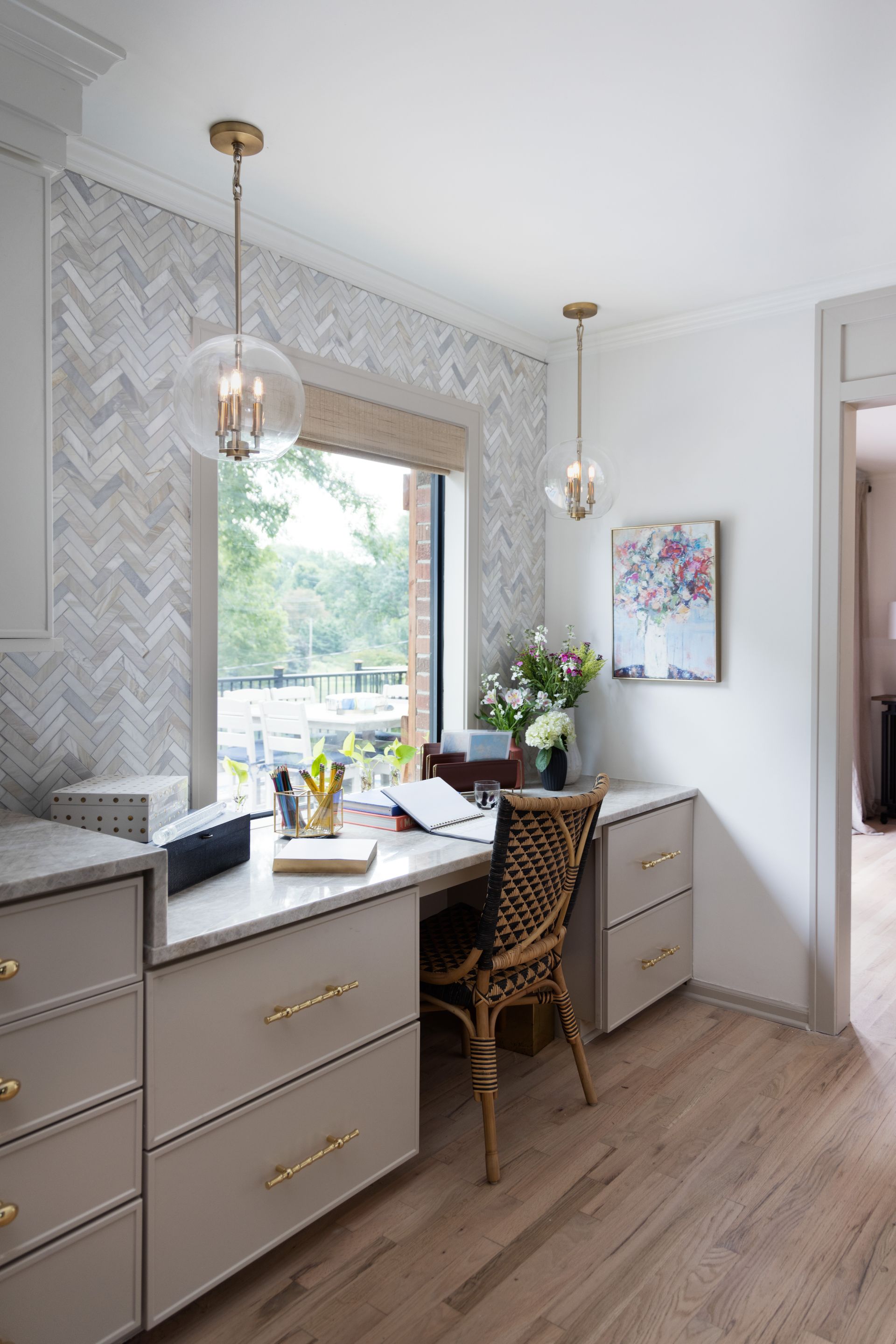 A room with a desk and chair in it and a window.