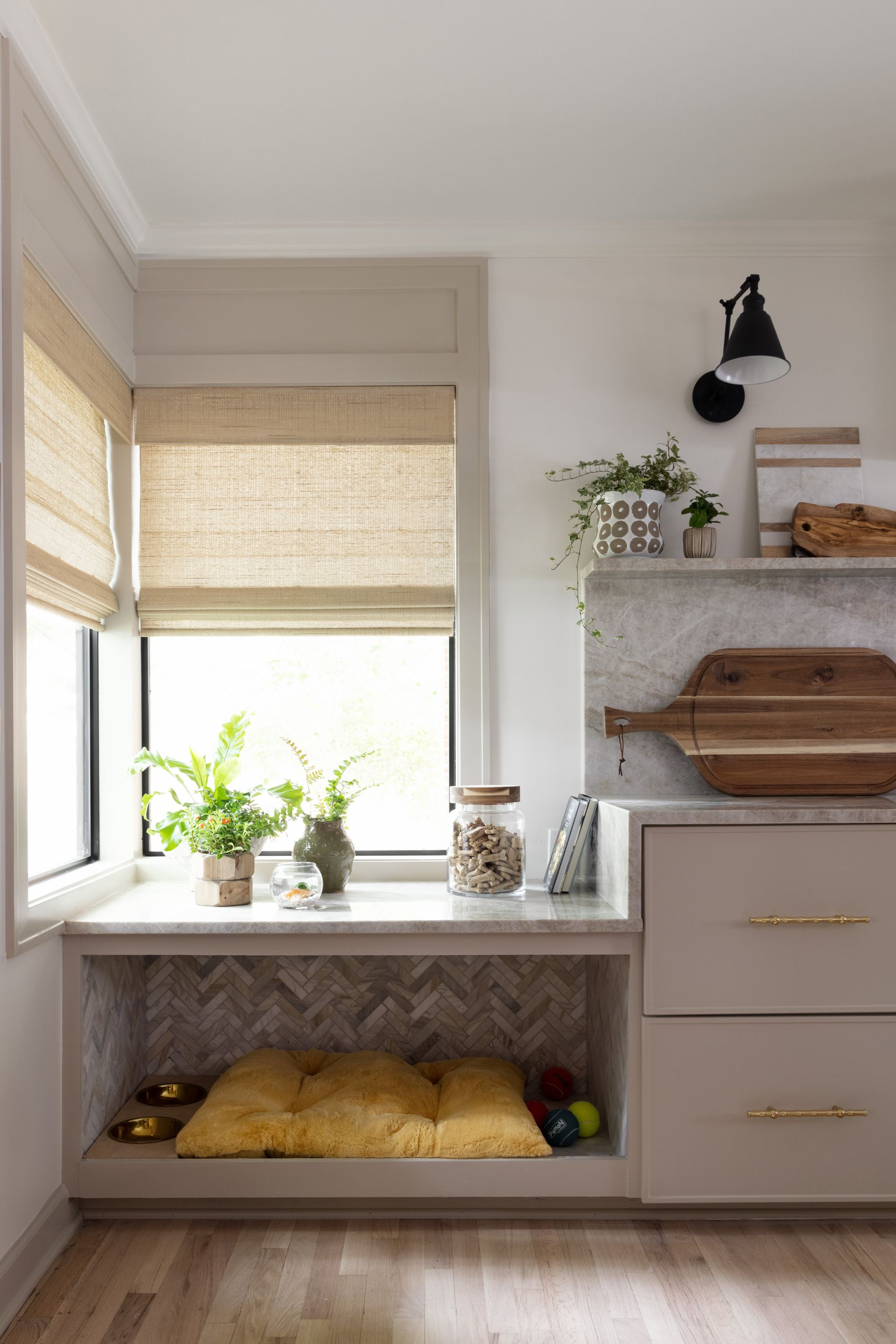 There is a dog bed under the window in the kitchen.