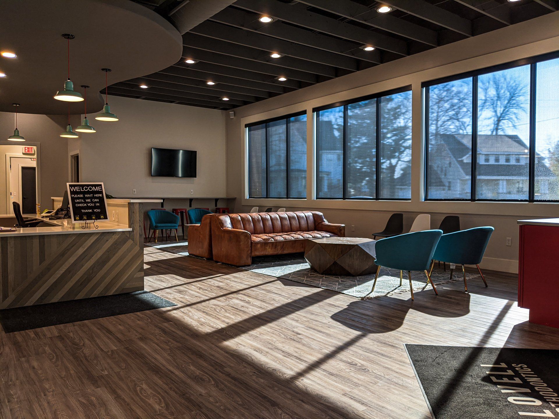 A living room with a couch , chairs , and a counter.