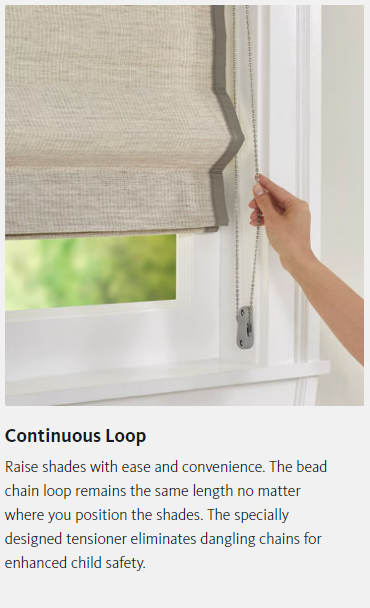 A person is holding a roman shade in a window.