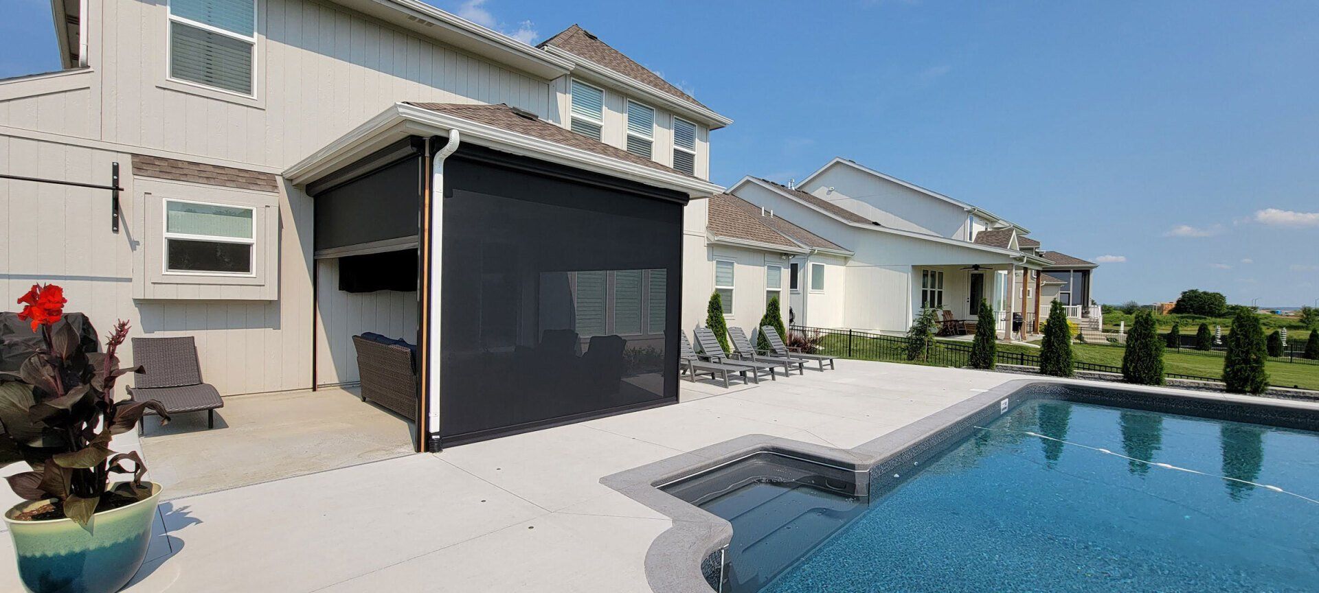 A large house with a swimming pool in front of it.