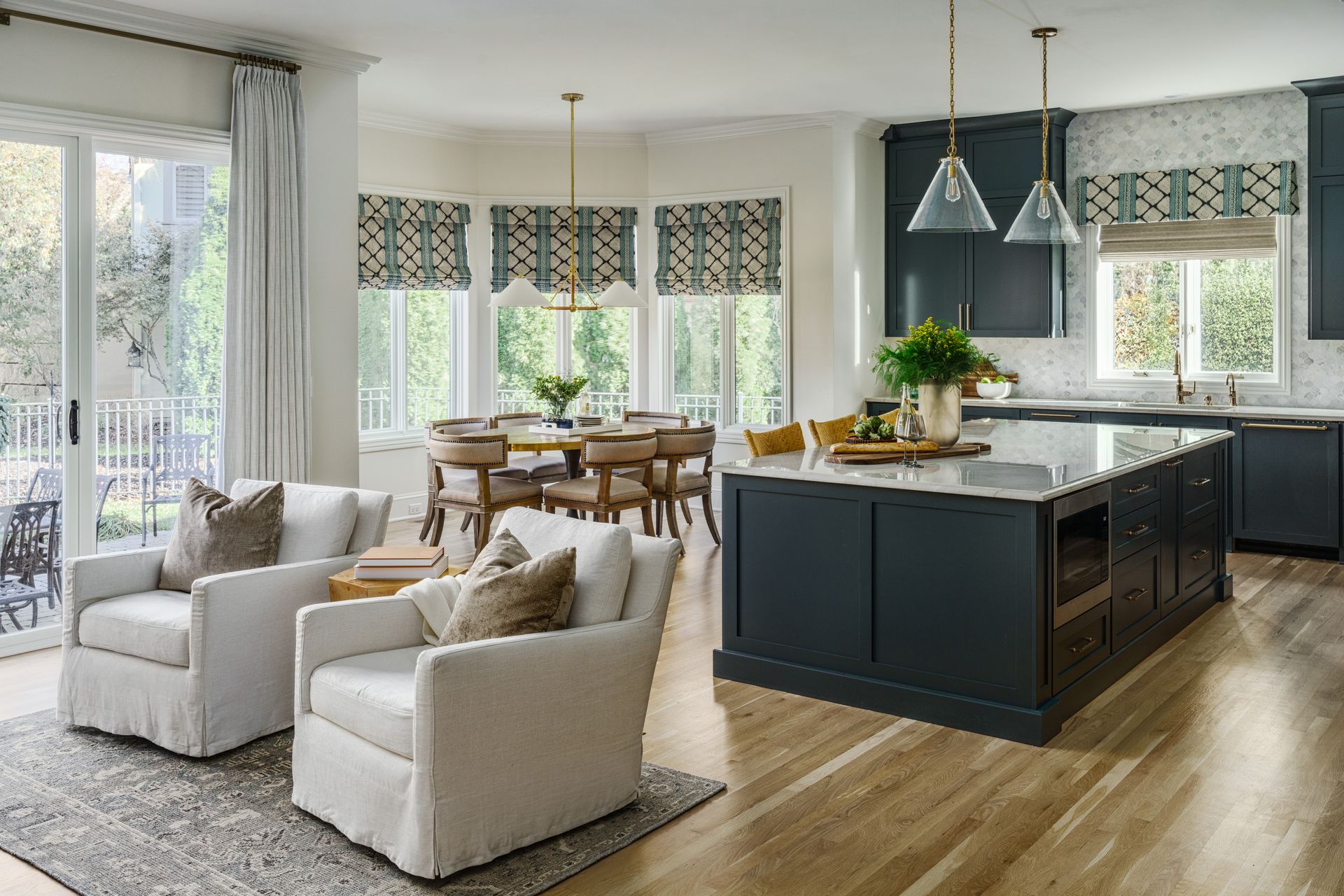 A living room filled with furniture and a kitchen with a large island.