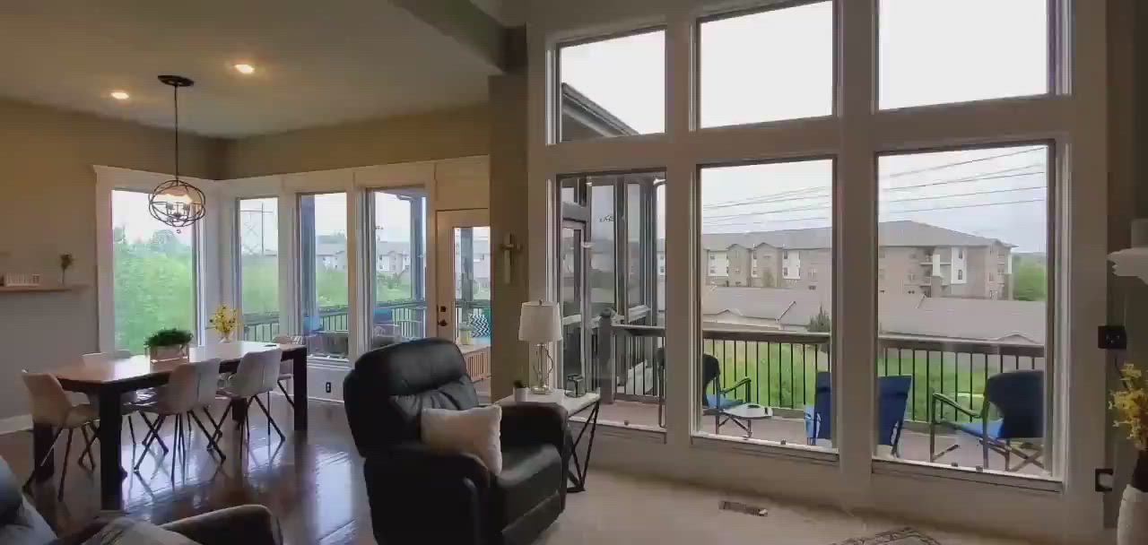 A living room filled with furniture and lots of windows.