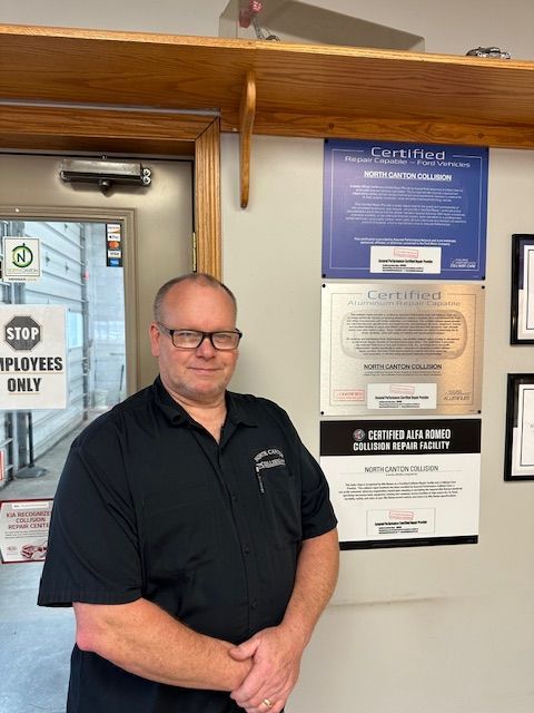 A man standing in front of a door that says stop employees only