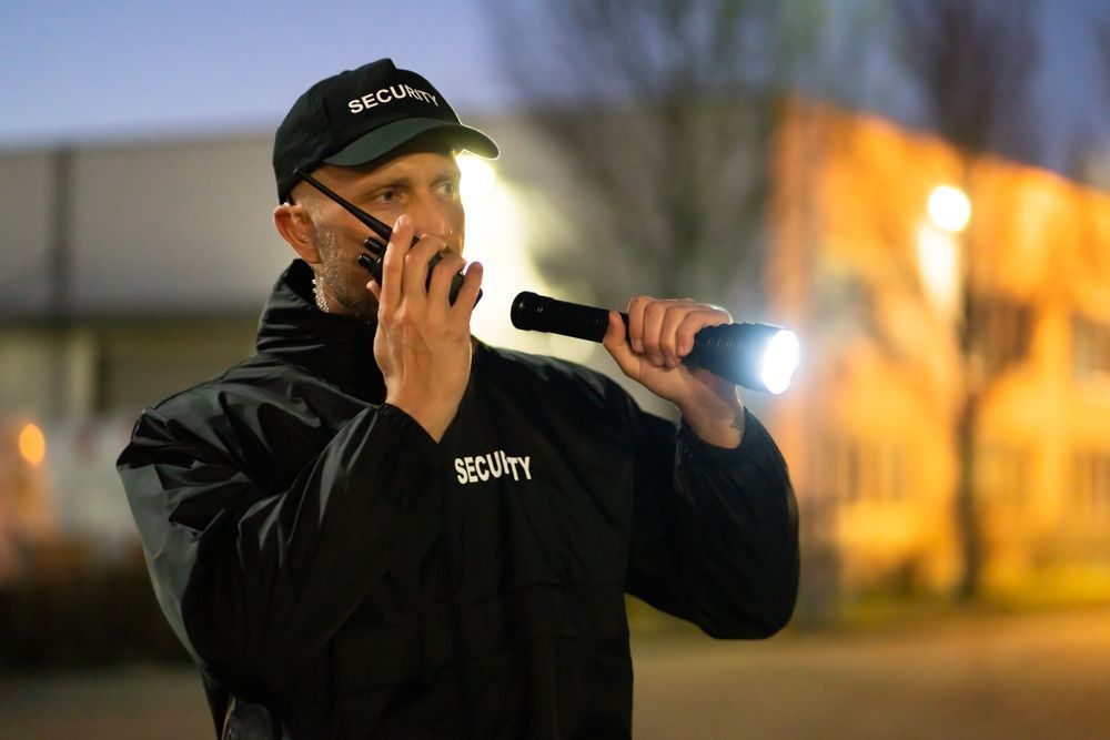 A Security Guard Is Talking On A Walkie Talkie — Asset Security Group In Port Macquarie, NSW