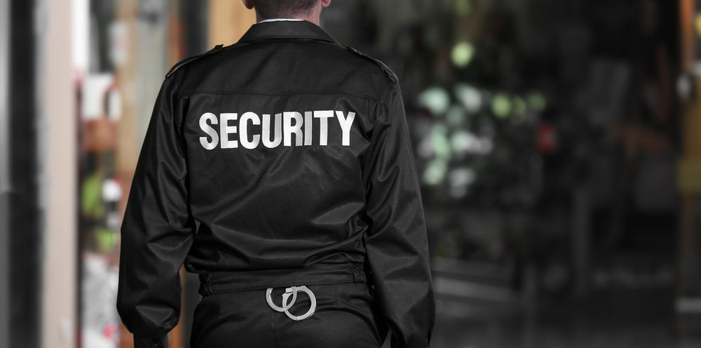 A Security Guard Wearing a Black Jacket With the Word Security — Asset Security Group In King Creek, NSW