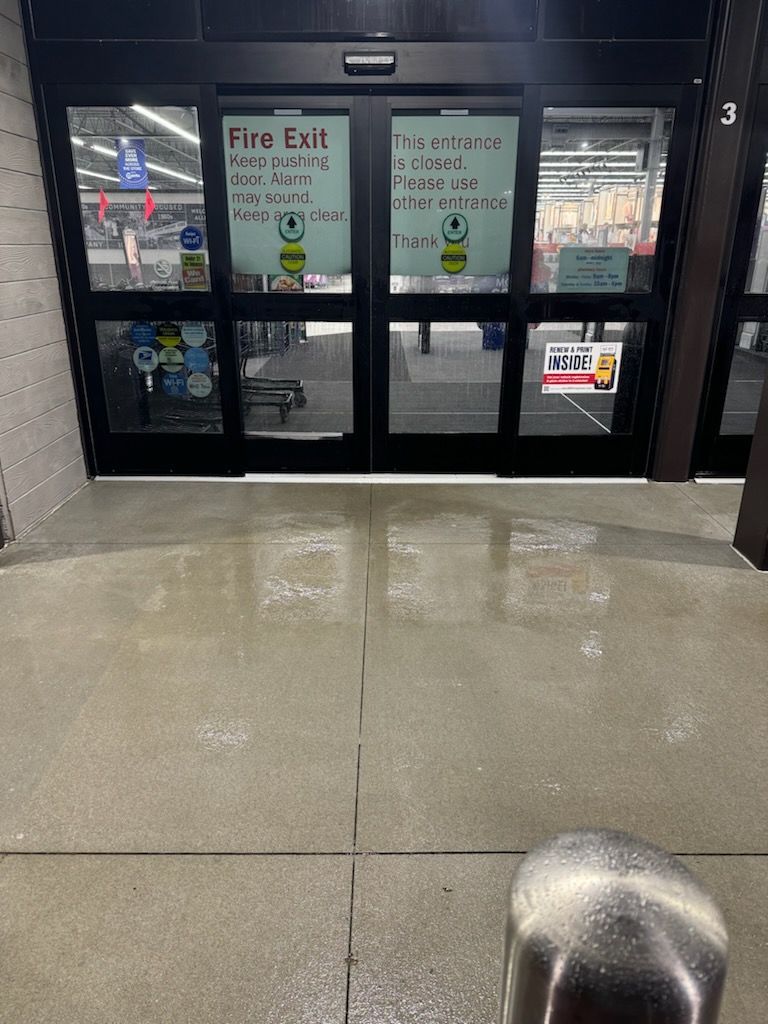 A white house with black shutters and a blue sky in the background. | Louisville, Ohio | Mongiardo Power Wash