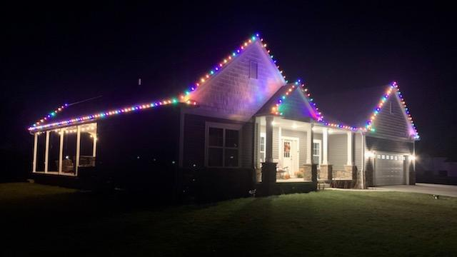 a house is decorated with christmas lights at night — Louisville, OH — Mongiardo Power Wash