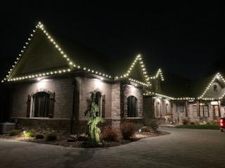 a large house with christmas lights on the roof is lit up — Louisville, OH — Mongiardo Power Wash
