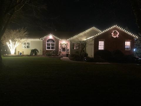 house with christmas lights on it is lit up — Louisville, OH — Mongiardo Power Wash