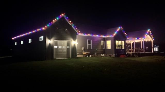 a house with christmas lights on it is lit up — Louisville, OH — Mongiardo Power Wash