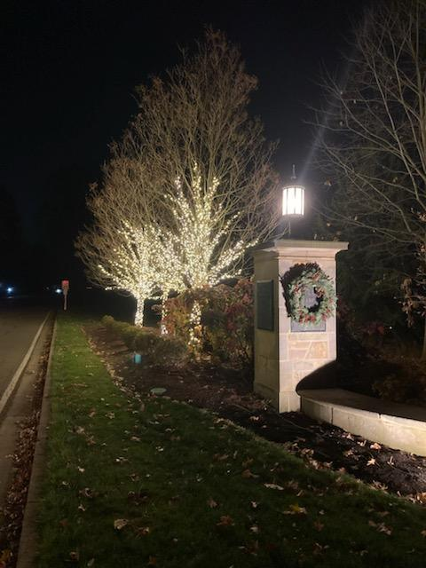 the trees are decorated with christmas lights and a wreath — Louisville, OH — Mongiardo Power Wash