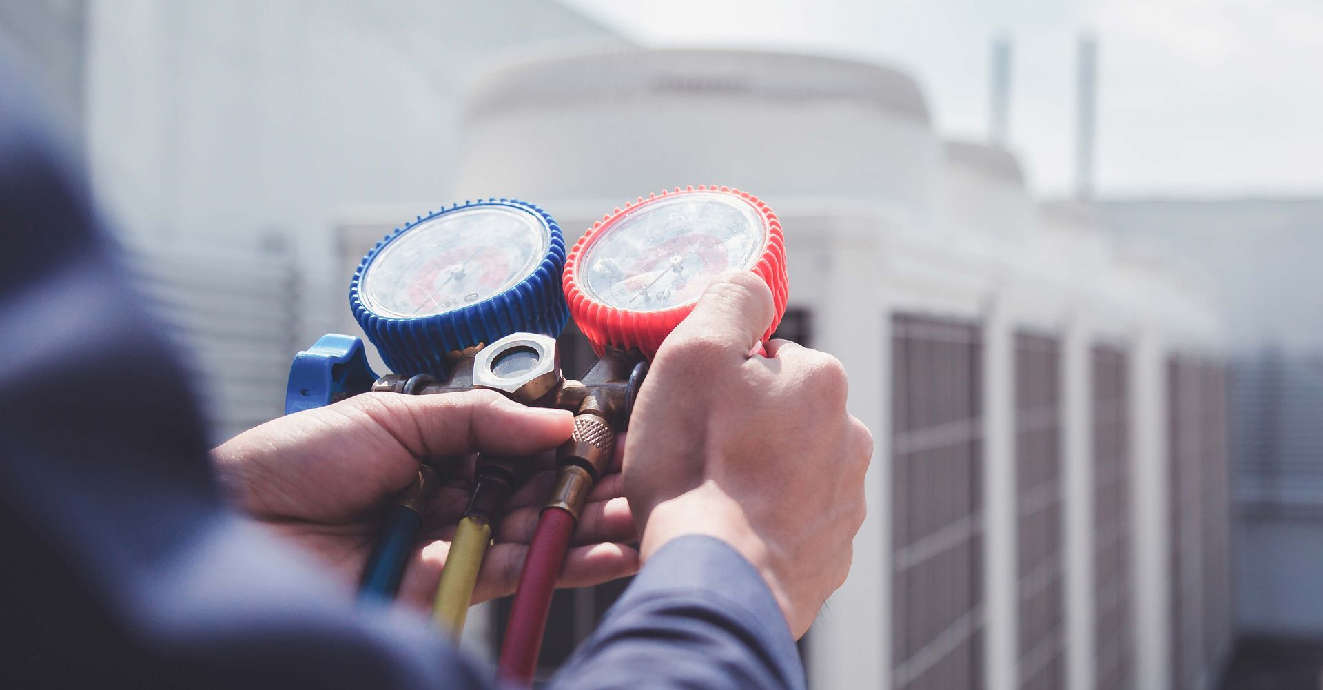 Technician is checking air conditioner ,measuring equipment for filling air conditioners.