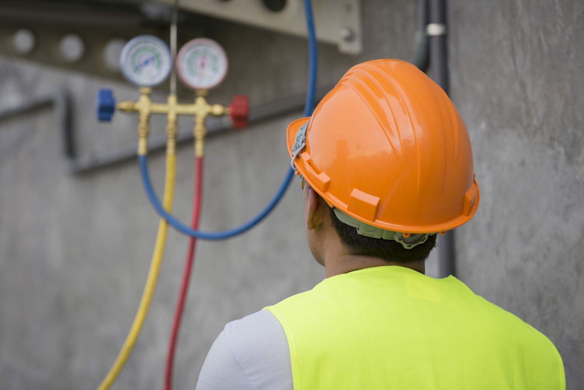 Air conditioning technician showcasing HVAC maintenance contractor inspecting an AC unit carefully.