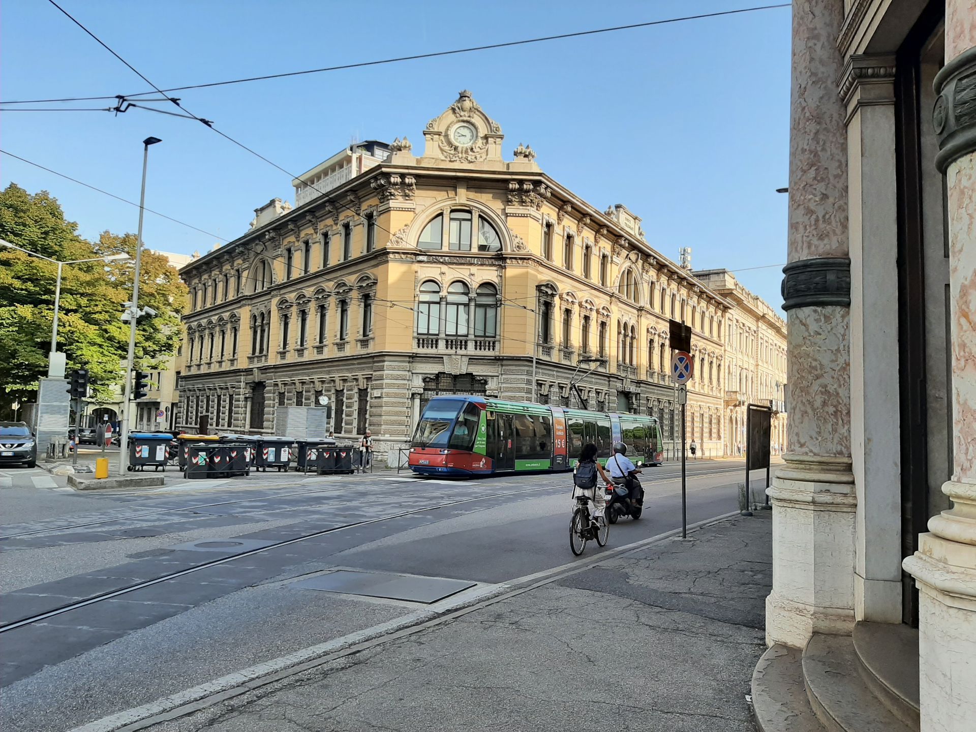 A man riding a motorcycle in front of a large building