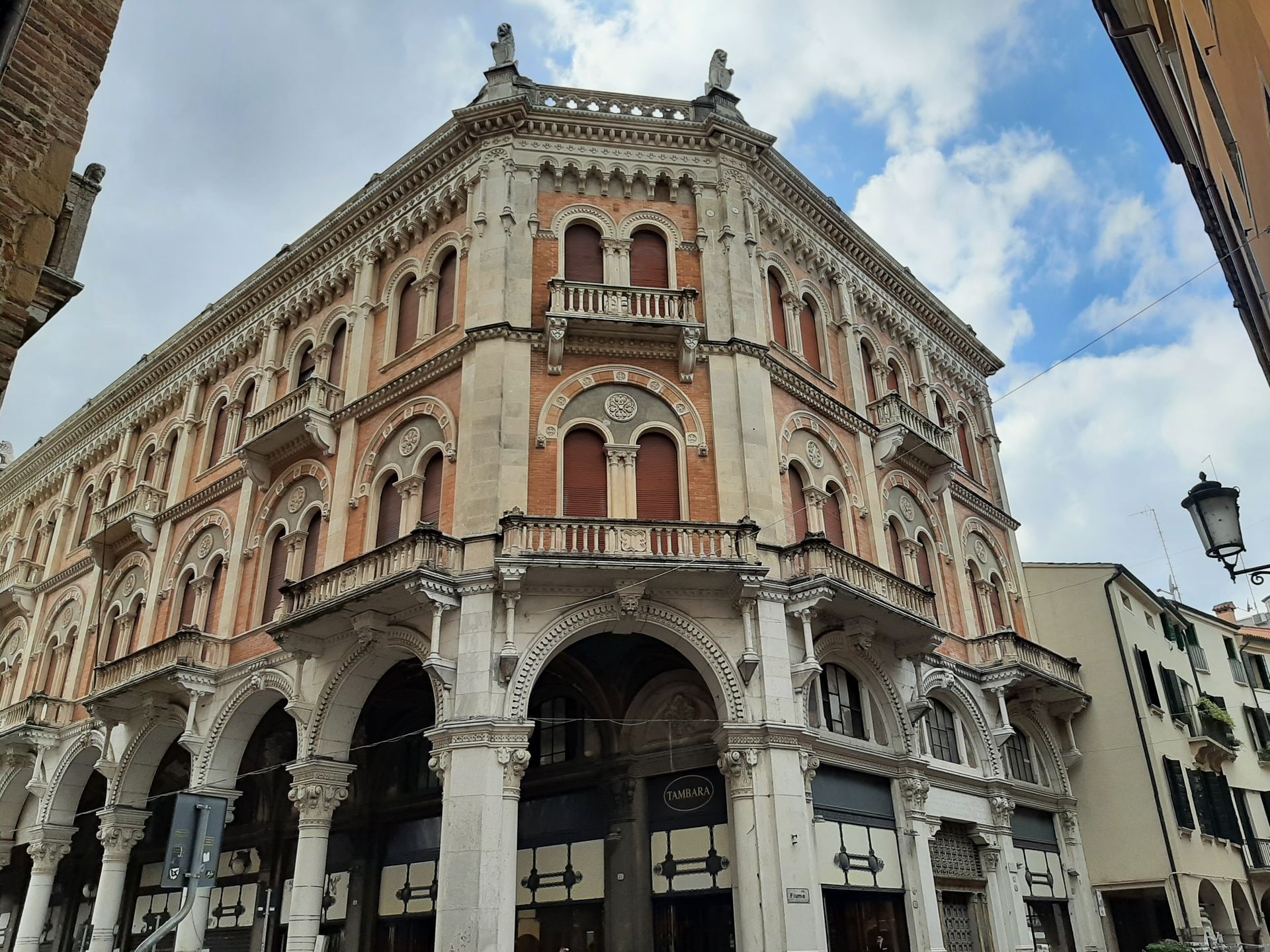 A large building with a balcony on the top of it