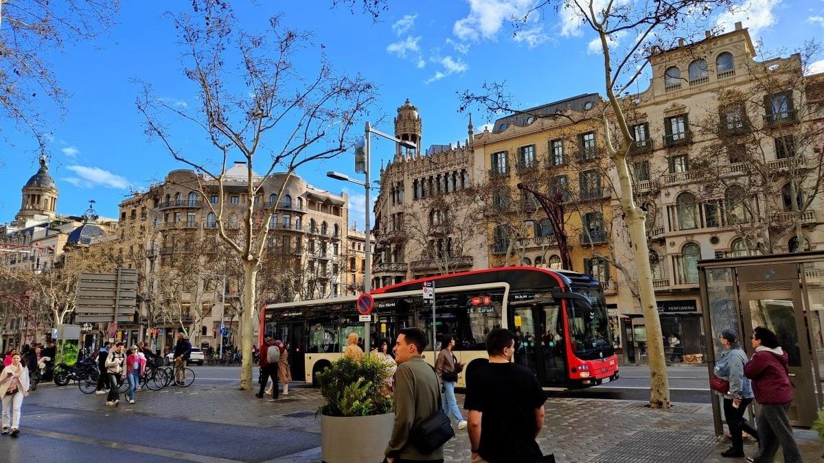 Barcelona Bus Station A group of people walking down a street in front of a bus