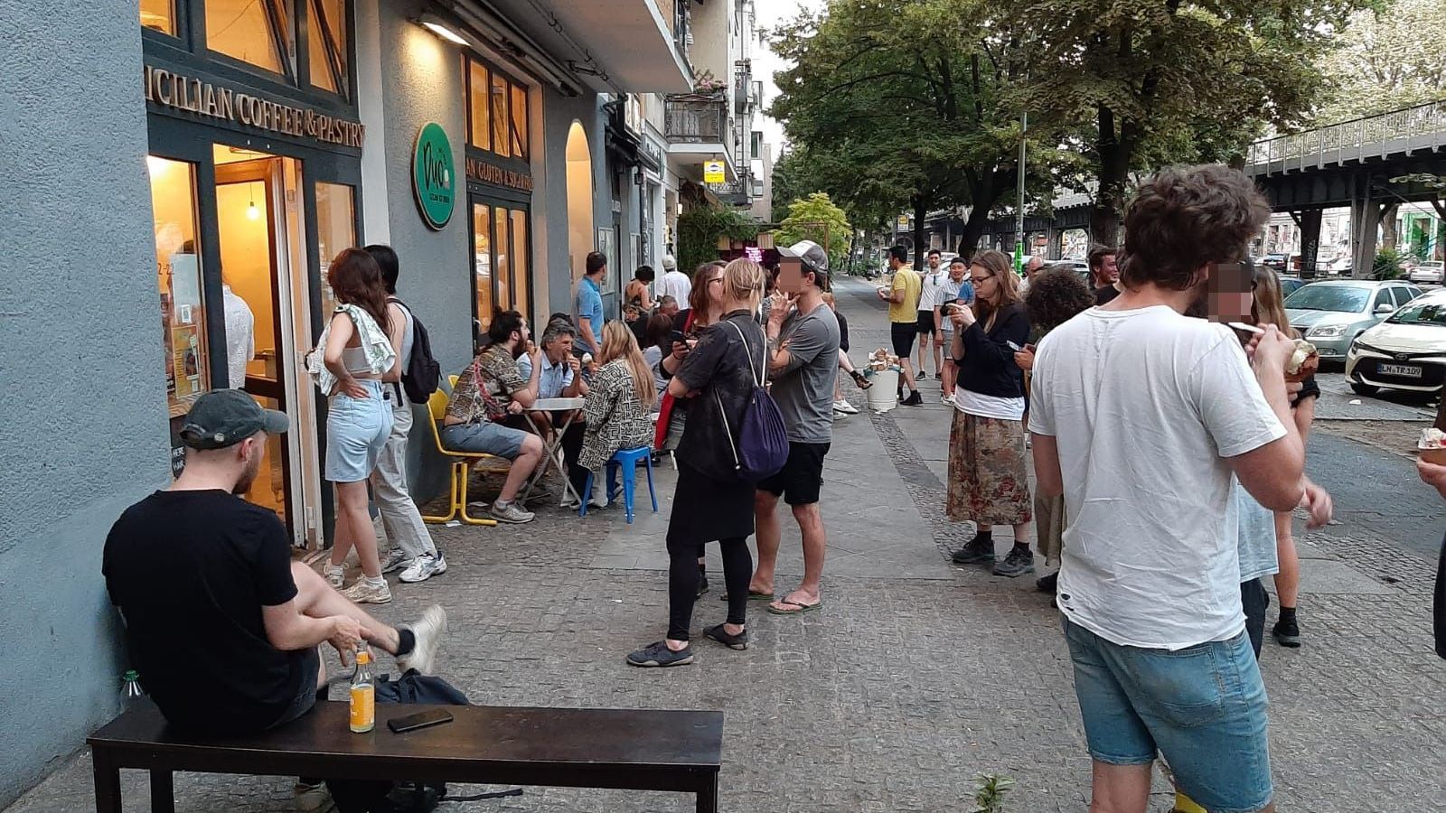 A group of people are standing outside of a building.