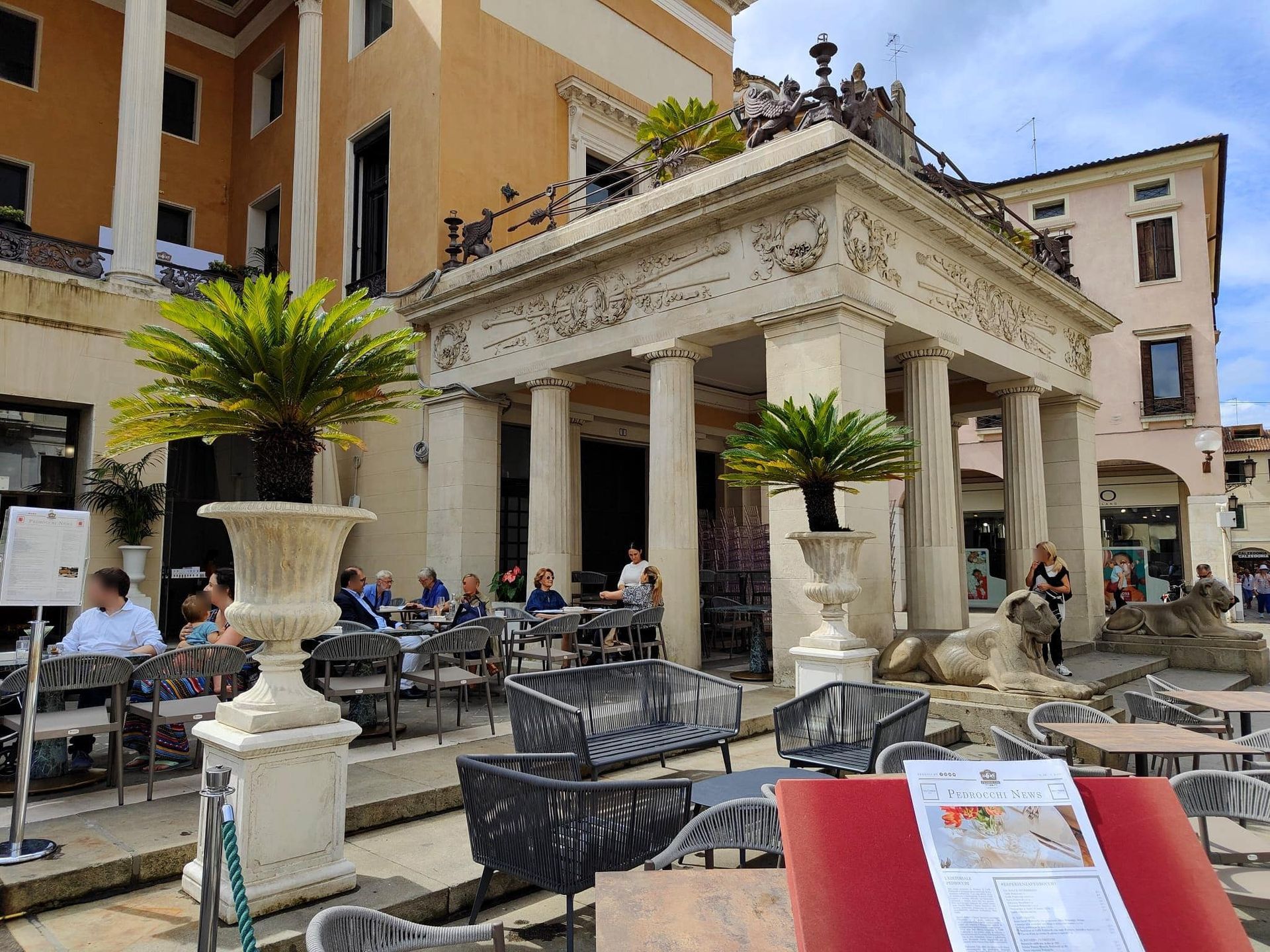 A menu is sitting on a table in front of a building