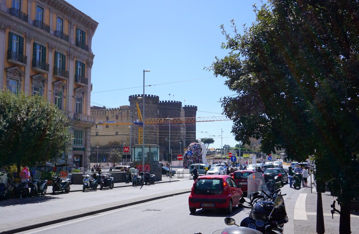 A busy street with cars and motorcycles on it