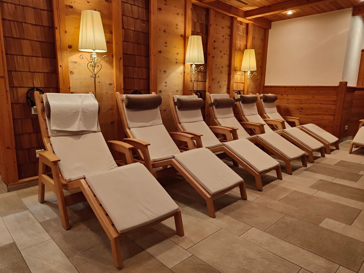 A row of lounge chairs in a room with wooden walls