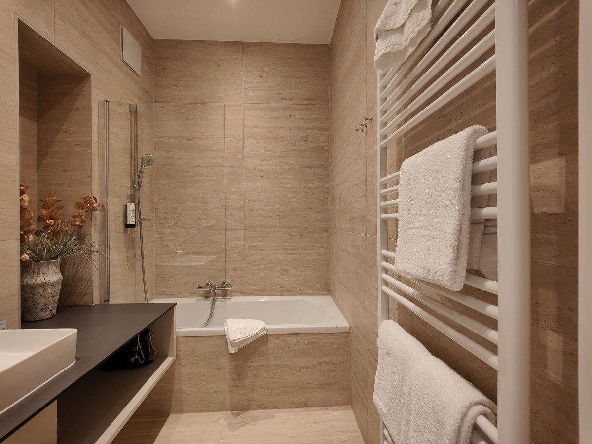 A bathroom with a bathtub and a towel rack