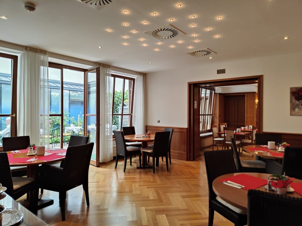 A restaurant with tables and chairs and a clock on the ceiling