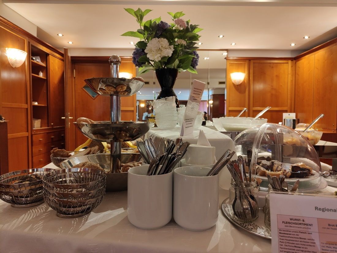 A buffet table with a vase of flowers on top