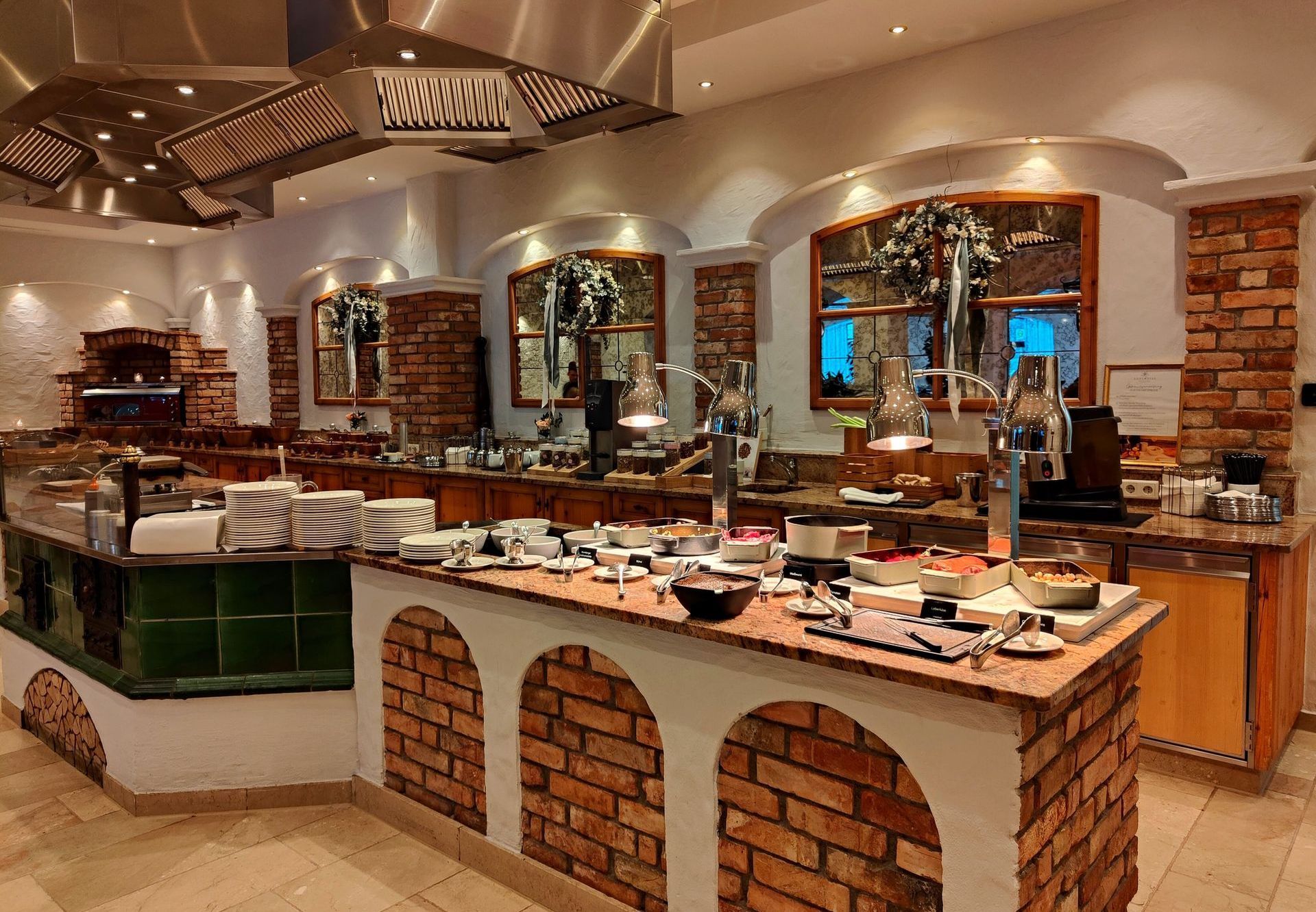 A buffet area with brick walls and stainless steel appliances  