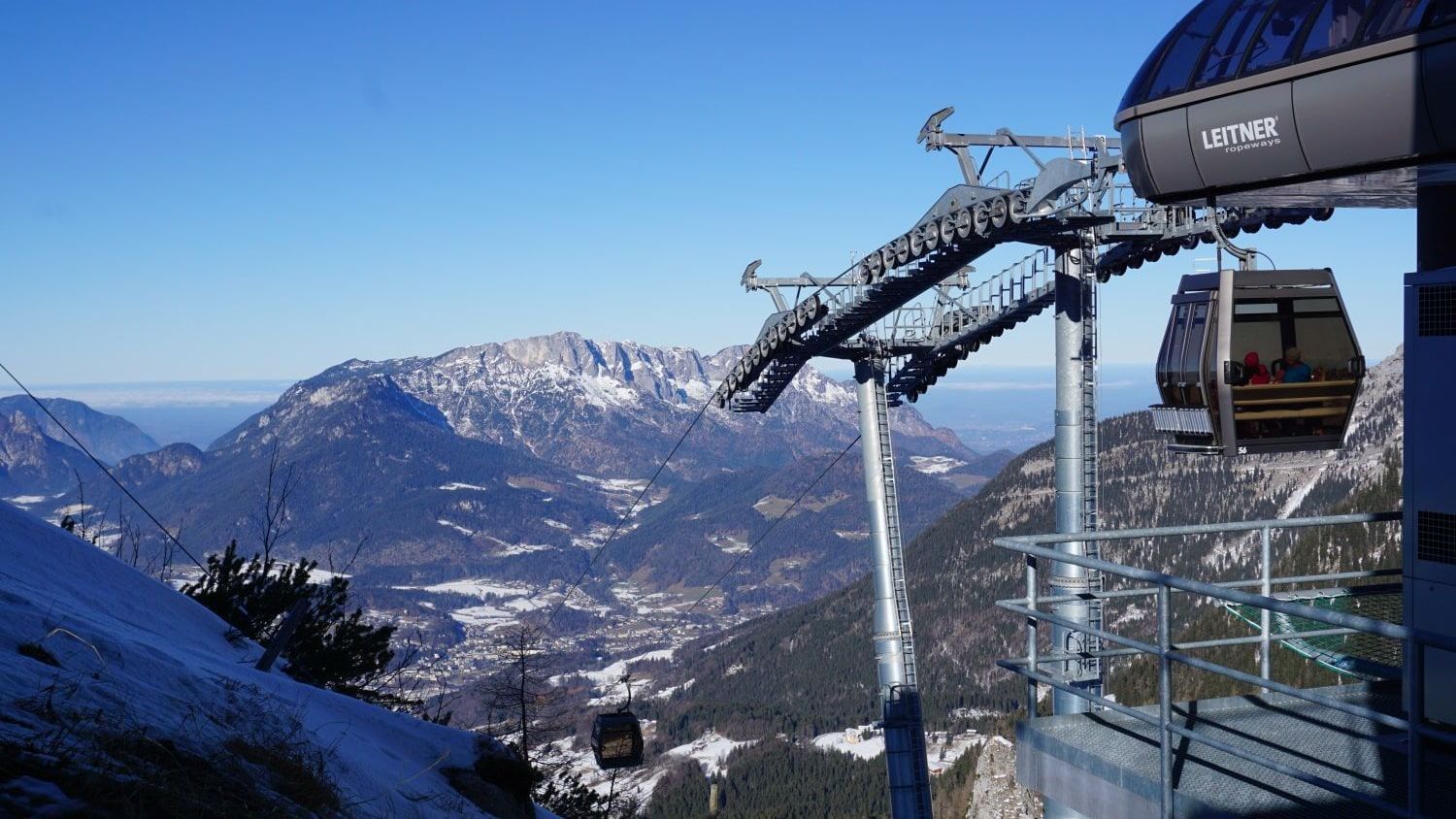 A ski lift is going up a snowy mountain