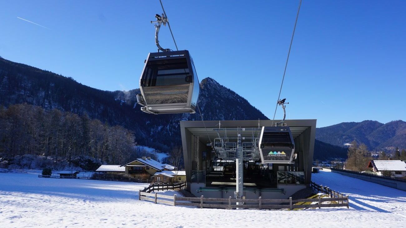 A ski lift is going up a snowy mountain