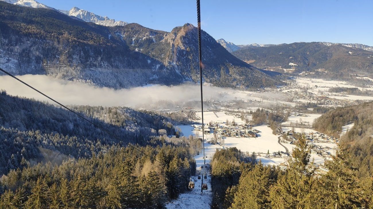 A ski lift going up a snowy mountain