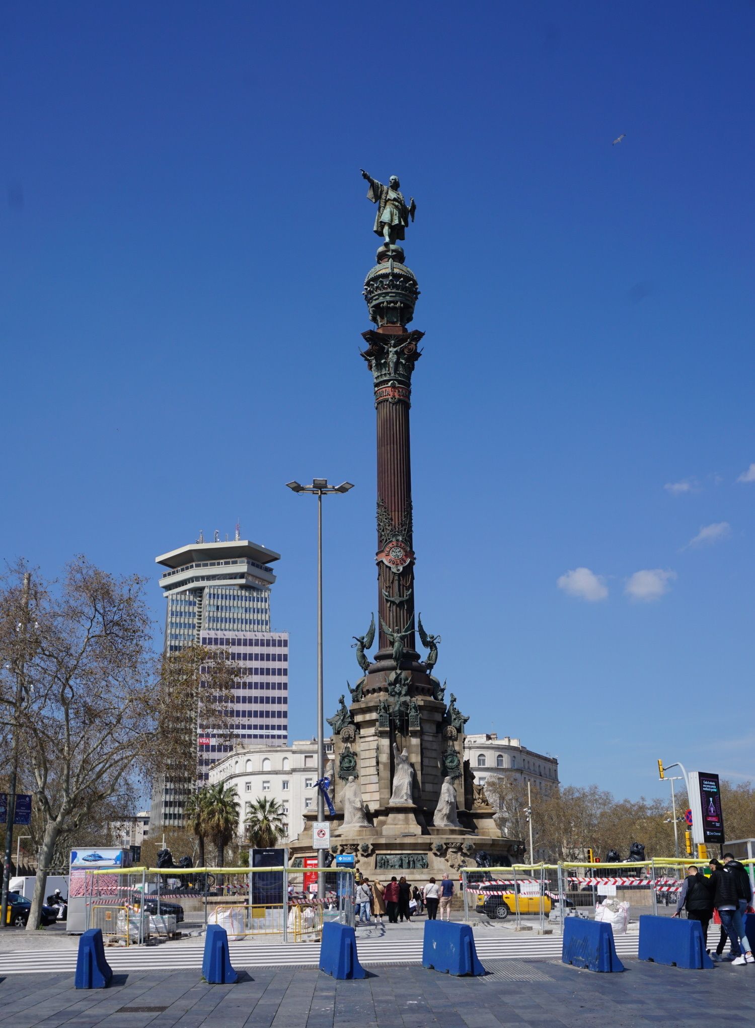 A large statue with a blue barrier in front of it