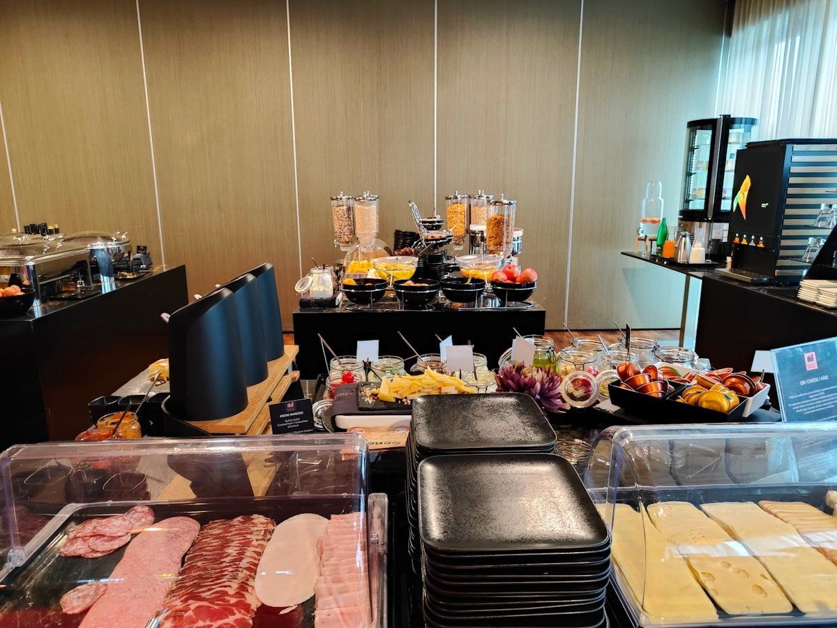 Breakfast buffet with various food options on display.